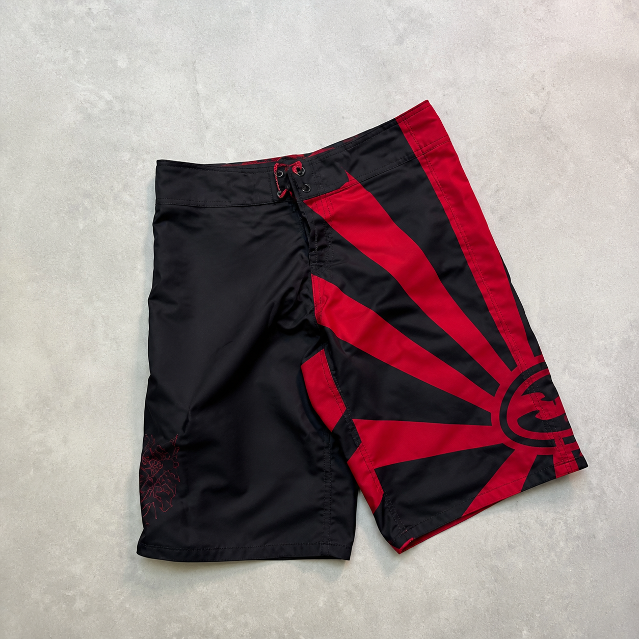 Blackout Red Sun Andy Irons-era boardshort reference in black / red